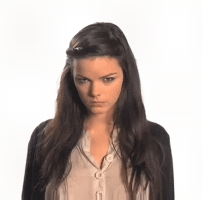 Woman With Dark Hair, Black Cardigan, Beige Shirt GIF