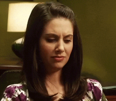 Woman With Dark Hair In Purple Floral Shirt GIF