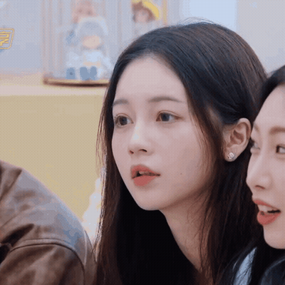 Woman With Doll In Display Case GIF