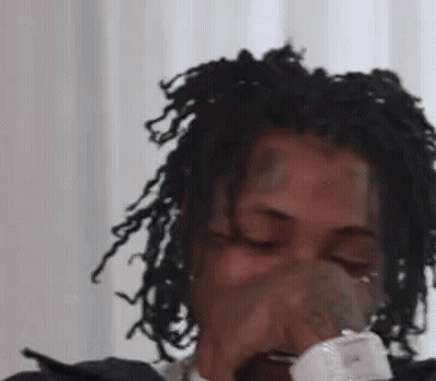 Woman With Dreadlocks Blowing Nose Into Tissue GIF