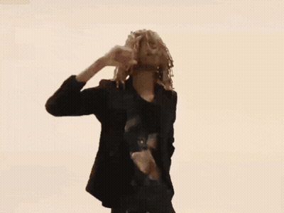 Woman With Dreadlocks Flexing In Black Shirt GIF