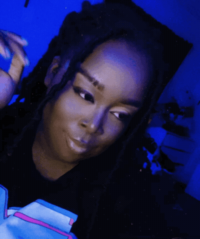 Woman With Dreadlocks In Black Shirt With Pink Stripe GIF