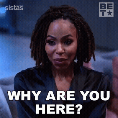 Woman With Dreadlocks Says Why Are You Here Sitting On Couch GIF
