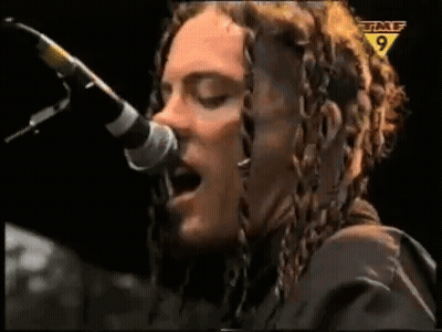 Woman With Dreadlocks Singing Into Microphone GIF
