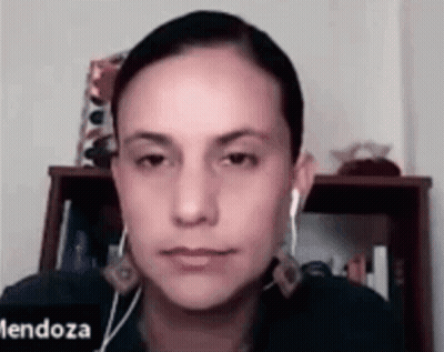 Woman With Ear Buds Looking At Camera GIF