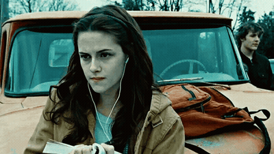 Woman With Ear Buds Standing In Front Of Truck GIF