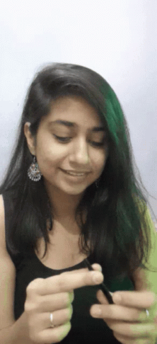 Woman With Earrings And Ring Holding Something GIF
