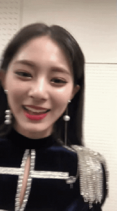 Woman With Earrings In Blue Top GIF