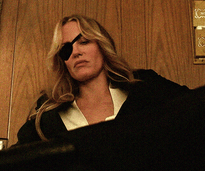 Woman With Eye Patch Looking Down GIF