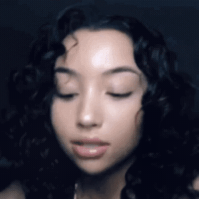 Woman With Eyes Closed And Curly Hair GIF