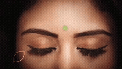 Woman With Eyes Closed And Green Bindi GIF
