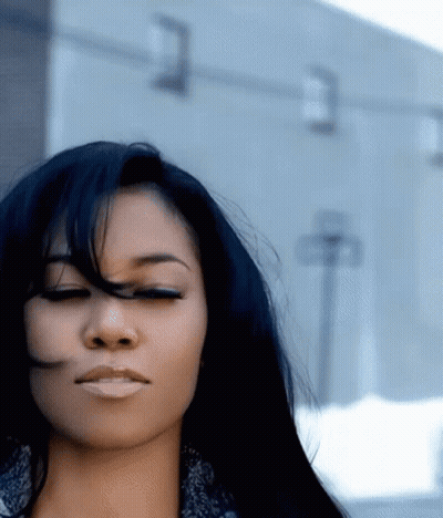 Woman With Eyes Closed And Hair Blowing In Wind GIF
