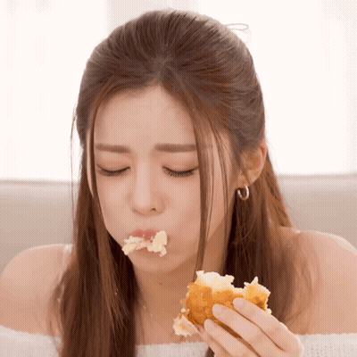 Woman With Eyes Closed Eating Bread GIF