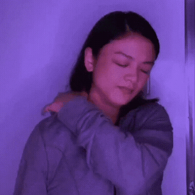 Woman With Eyes Closed Holding Shoulder GIF