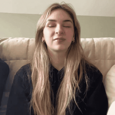 Woman With Eyes Closed In Black Sweater GIF