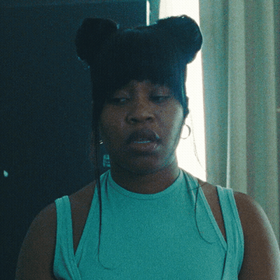Woman With Eyes Closed In Blue Tank Top And Earrings GIF