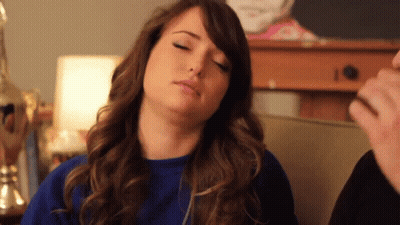 Woman With Eyes Closed In Blue Top GIF