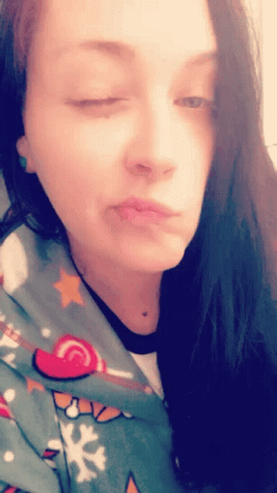 Woman With Eyes Closed In Christmas Sweater GIF