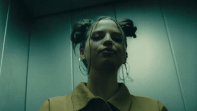 Woman With Eyes Closed In Elevator GIF