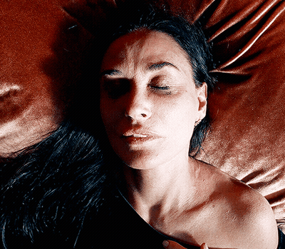 Woman With Eyes Closed Laying On Bed GIF