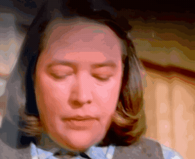 Woman With Eyes Closed Looking At Camera GIF