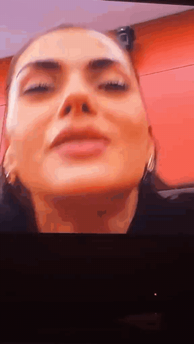 Woman With Eyes Closed On Red Background GIF