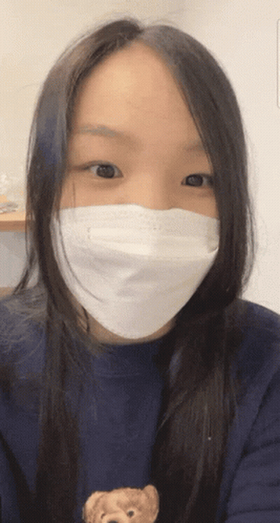 Woman With Face Mask And Teddy Bear Sweater GIF