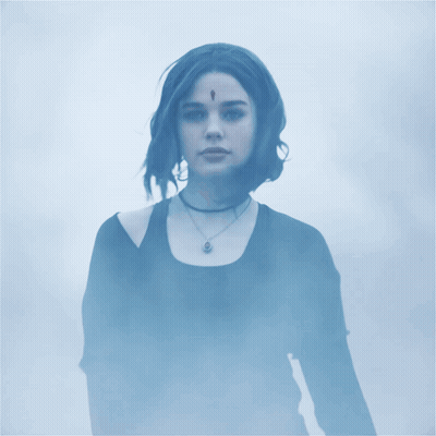 Woman With Feather On Forehead In Foggy Area GIF