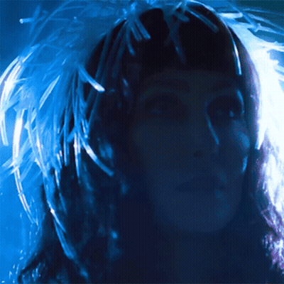 Woman With Feathers In Hair GIF