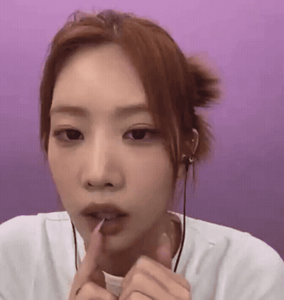 Woman With Finger In Mouth Purple Background GIF