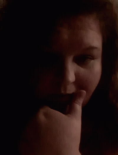 Woman With Finger On Mouth GIF