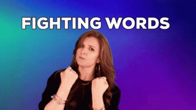 Woman With Fist In Air Saying Fighting Words GIF