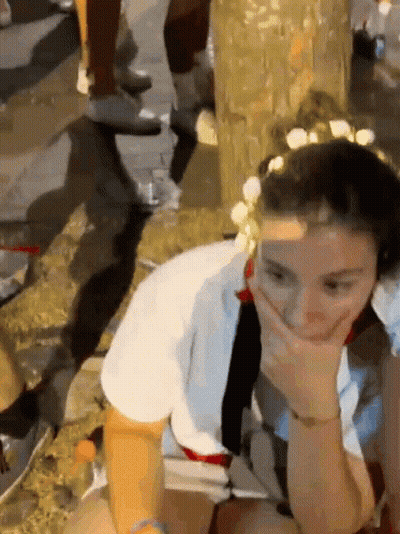 Woman With Flower Crown Covering Mouth GIF