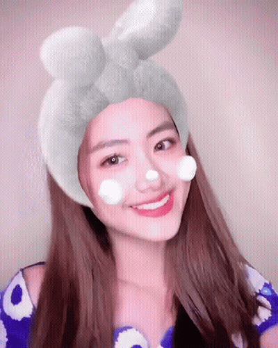 Woman With Flower Crown Holding Red Apple GIF