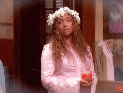 Woman With Flower Crown Holding Red Apple GIF