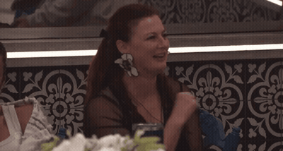 Woman With Flower Earring At Table GIF