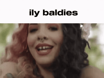 Woman With Flower In Hair And Illy Baldies GIF