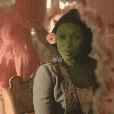 Woman With Flower In Hair Looking In Mirror GIF