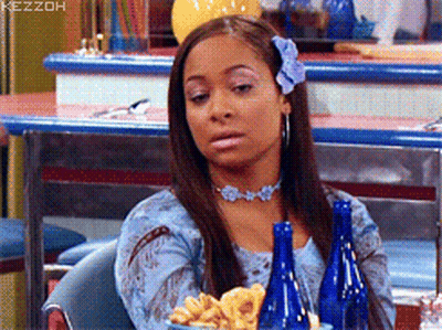 Woman With Flower In Hair Sitting At Table GIF