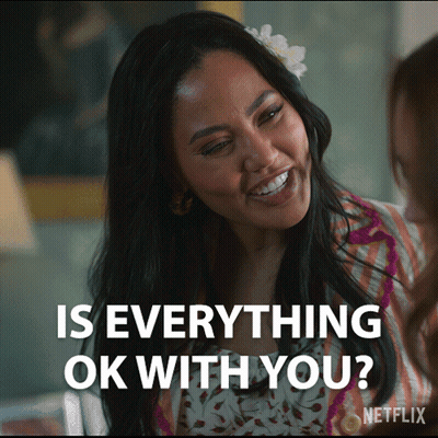 Woman With Flower In Hair Smiling Asking Everything Ok GIF