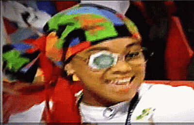 Woman With Glasses And Colorful Head Scarf Smiling GIF
