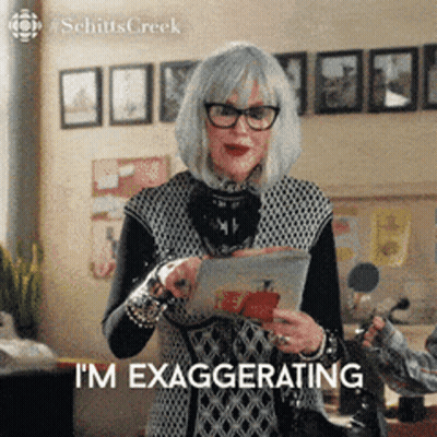 Woman With Glasses And Gray Hair Holding Tablet Saying I'm Exaggerating GIF