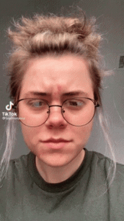 Woman With Glasses And Green Shirt With TikTok Sticker On Face GIF