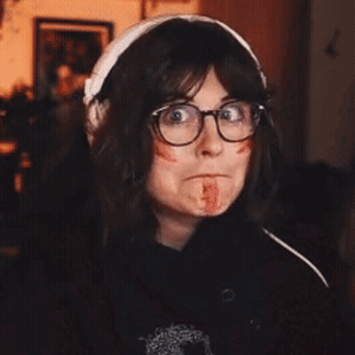 Woman With Glasses And Headphones Bloodied Face GIF