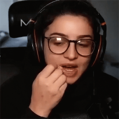 Woman With Glasses And Headphones Eating GIF