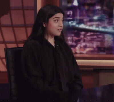Woman With Glasses And Headphones Making Funny Face Saying Little Ups And Downs GIF