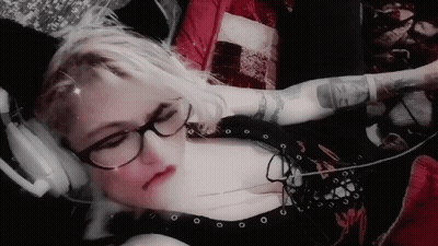 Woman With Glasses And Headphones Showing Arm Tattoo GIF