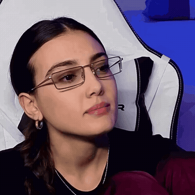 Woman With Glasses And Hoop Earrings Sitting In Chair GIF