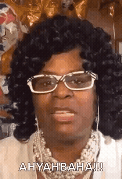 Woman With Glasses And Necklace Making A Face GIF