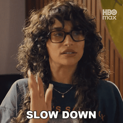 Woman With Glasses And Necklace Saying Slow Down GIF